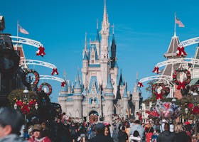 pexels-photo-3411132-3411132 A busy day at Orlando's Magic Kingdom with crowds enjoying holiday decorations.